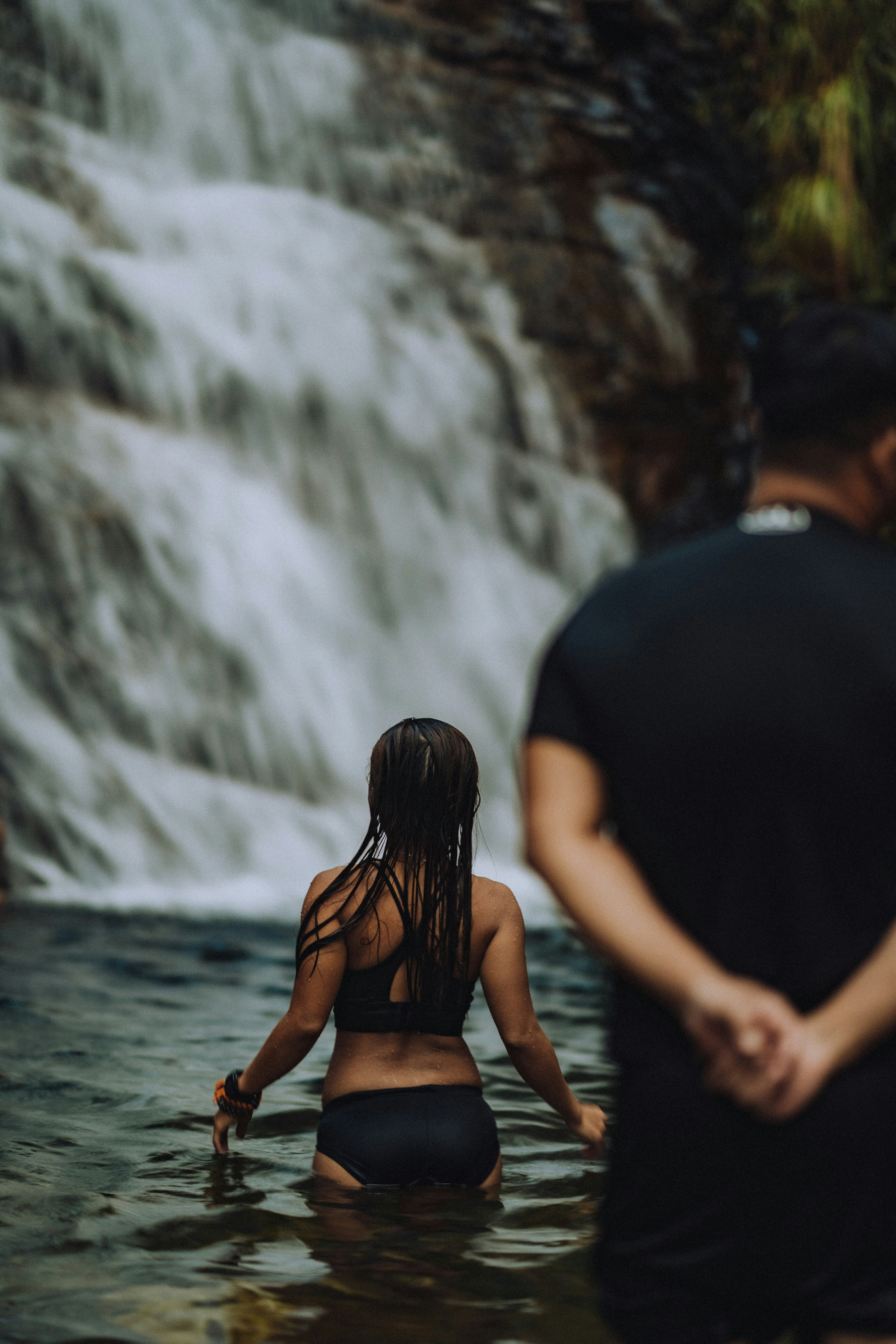 man in black shirt standing beside woman in black shirt