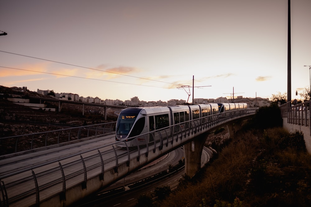 blue and white train on rail during daytime