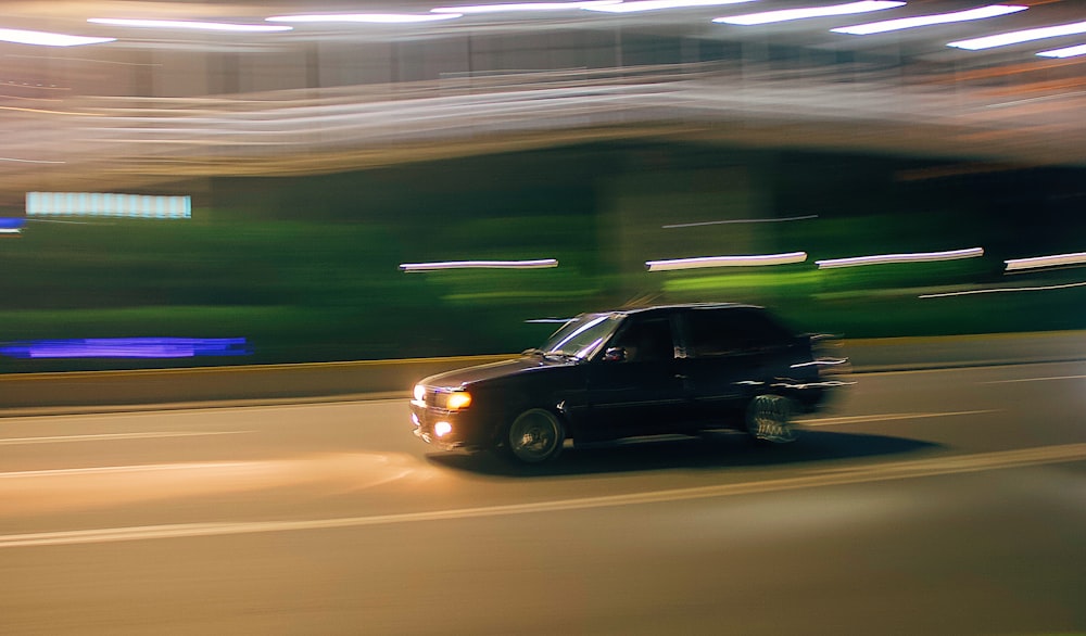 black sedan on road during daytime