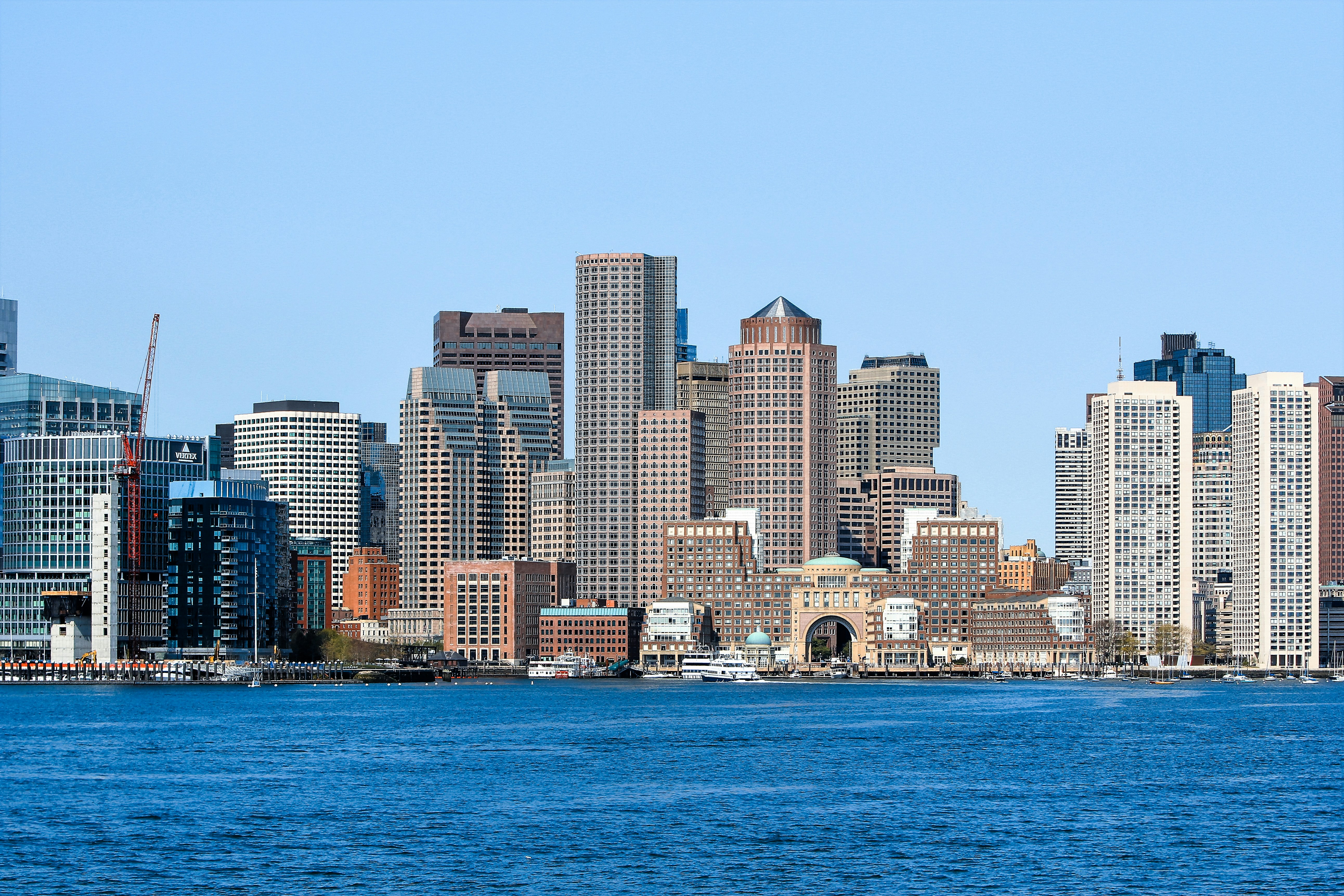 city skyline across body of water during daytime