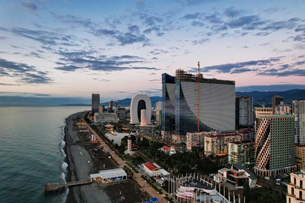 Batumi’s skyline of glass towers along the Black Sea shore at dusk