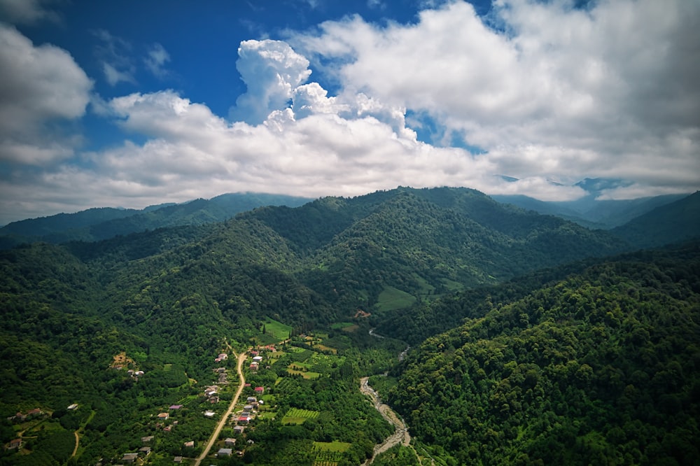 green mountains under white clouds and blue sky during daytime