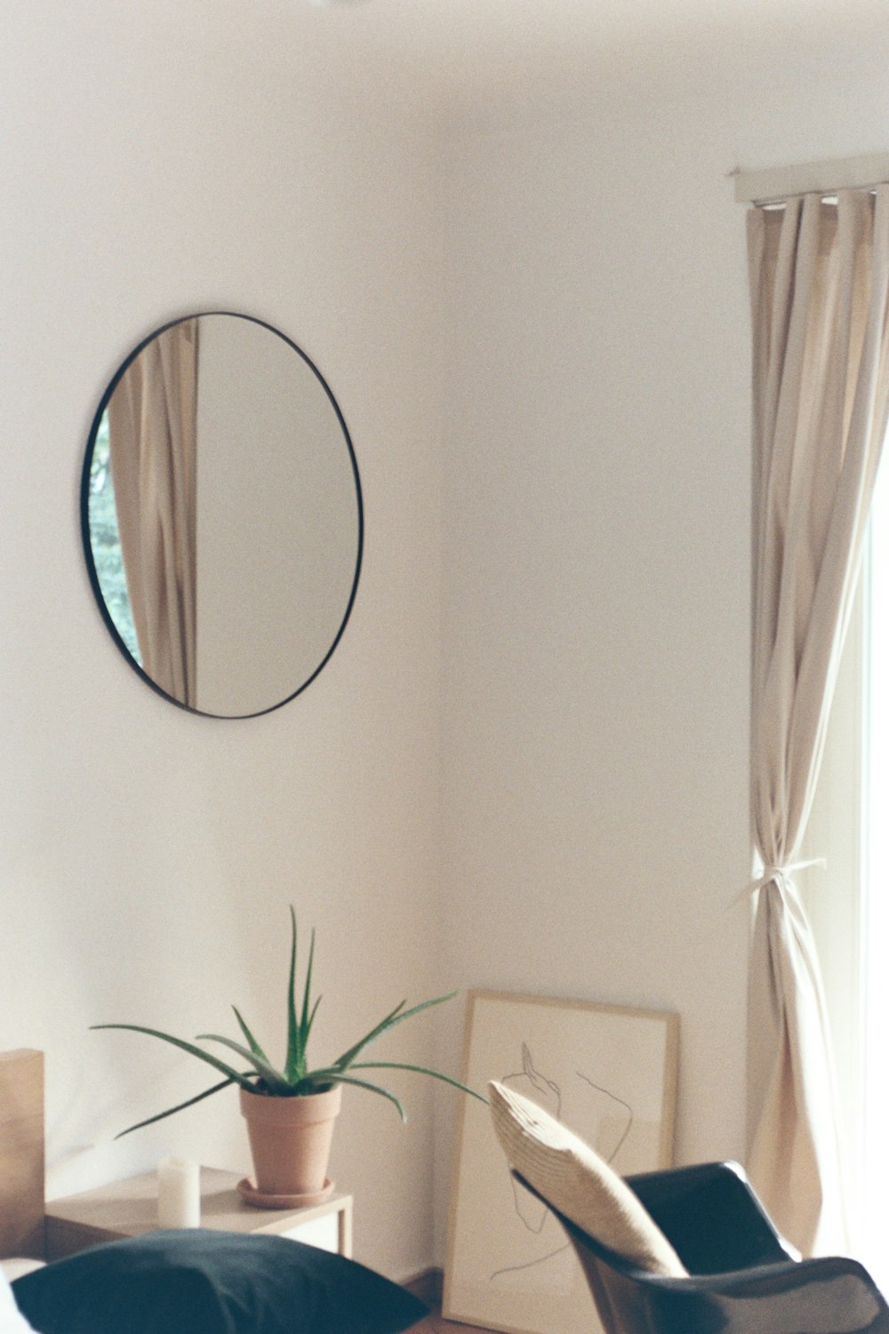 round mirror with brown wooden frame