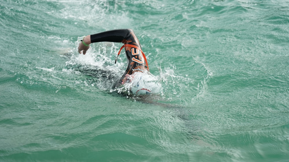 man surfing on sea waves during daytime