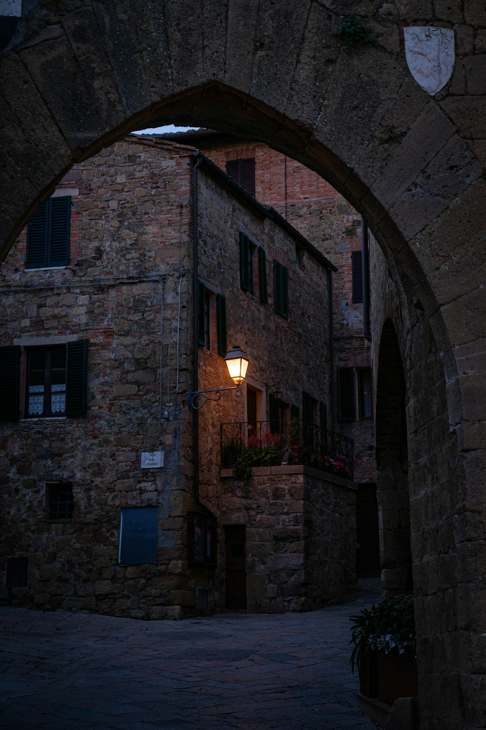 brown brick building with light turned on during daytime