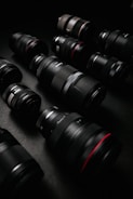 black dslr camera lens on black surface