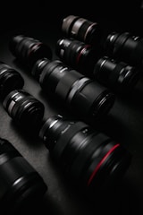 black dslr camera lens on black surface
