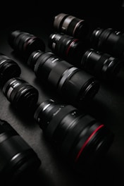 A collection of vibrant camera lenses arranged in a circle on a dark surface.