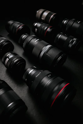 A colorful collection of camera lenses and accessories spread out on a table.