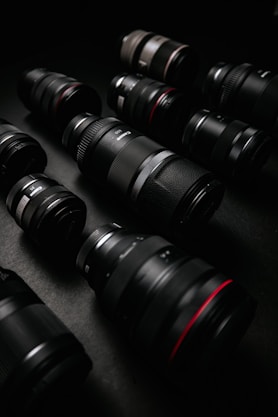 black dslr camera lens on black surface