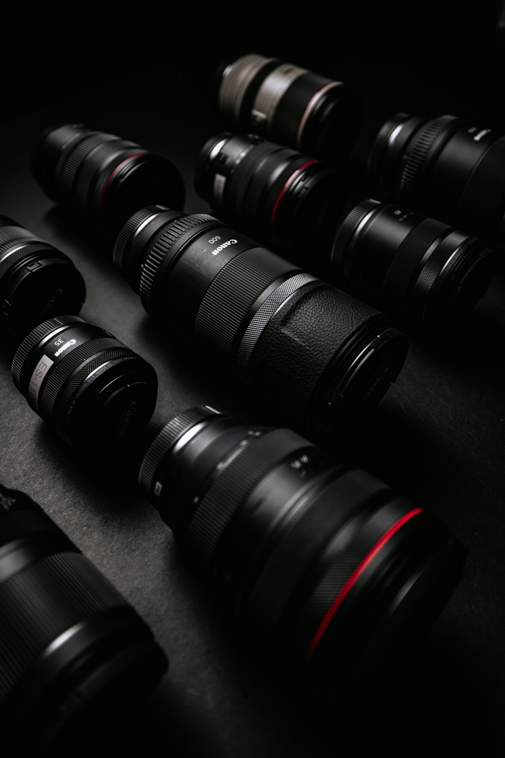 black dslr camera lens on black surface