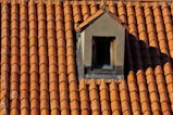 A roof with a birdhouse on top of it