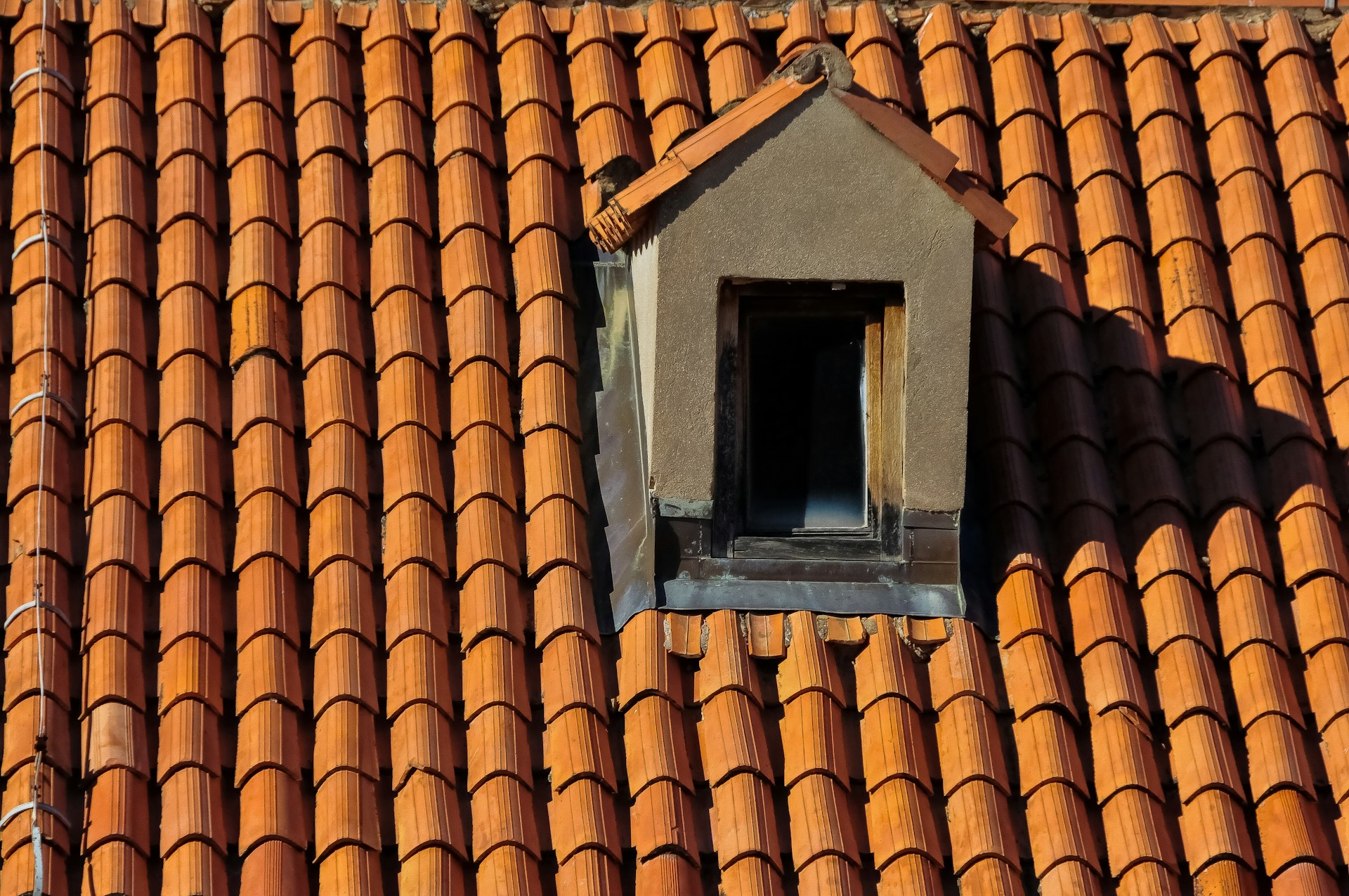 A roof with a birdhouse on top of it