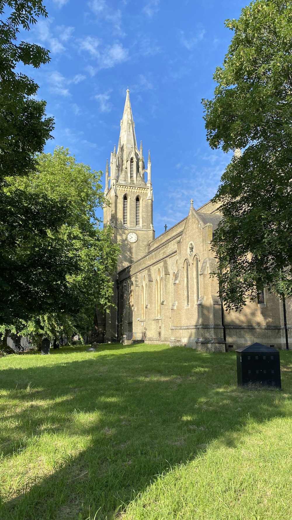 brown concrete church near green trees during daytime