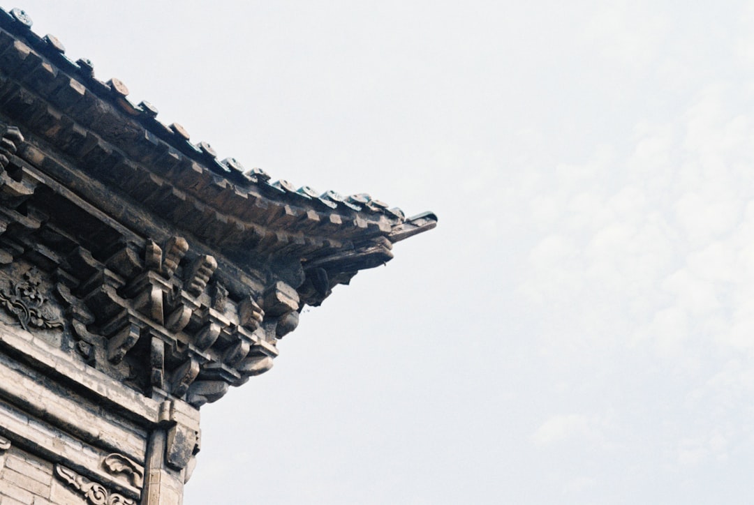 brown wooden temple under white sky during daytime