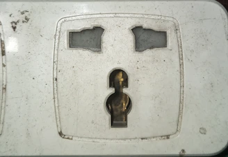 Close-up of a damaged electrical outlet being replaced.