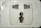 A close-up view of a dirty electrical wall socket with visible grime and stains. The socket design is for a plug with two flat and one round pin. The surrounding area shows signs of wear and lack of maintenance.