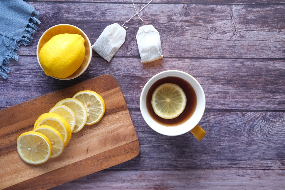 sliced lemon on brown wooden chopping board