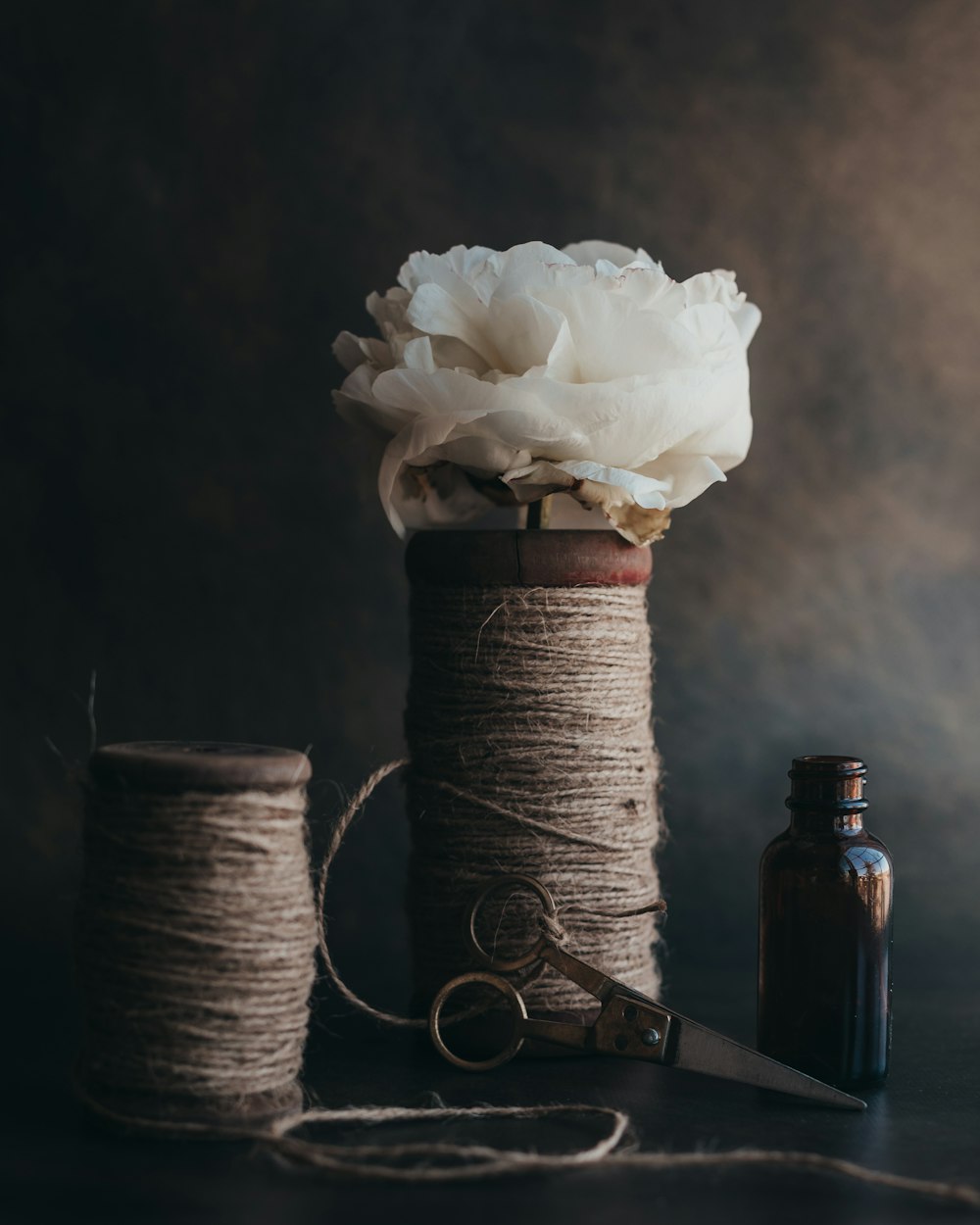 white rose on brown bottle