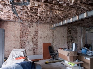 black chair near brown brick wall