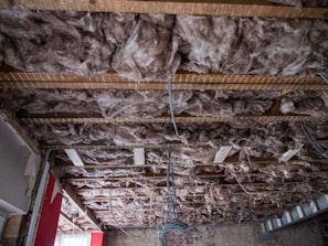 View of a renovated room showcasing new insulation behind drywall