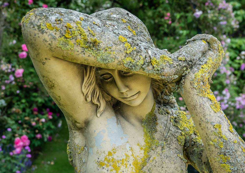 womans face covered with white and yellow floral textile