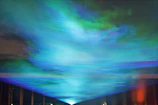 Aurora borealis-inspired waveforms glowing against a dark background.