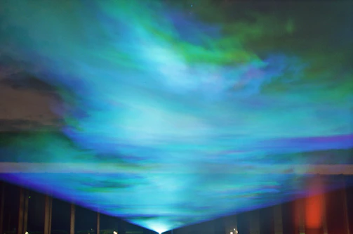 Aurora borealis-inspired waveforms glowing against a dark background.