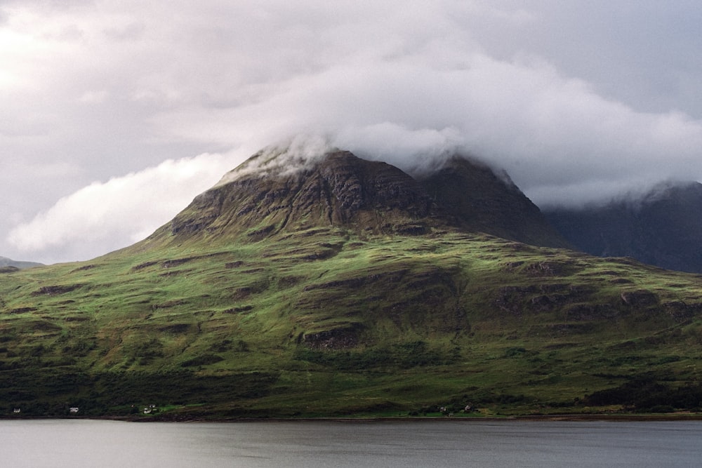 green and brown mountain under white clouds