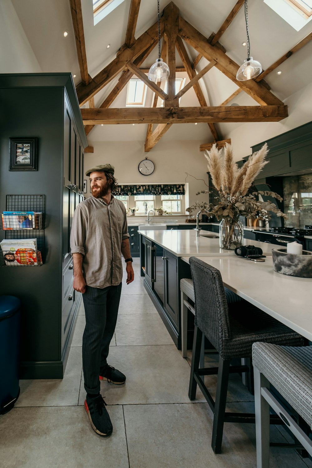 man in gray dress shirt standing near counter