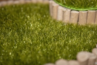 Close-up of vibrant green synthetic grass rolls ready for sale.
