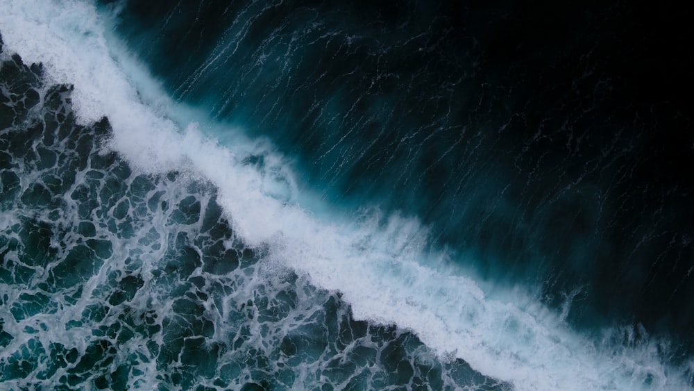 ocean waves crashing on shore during daytime