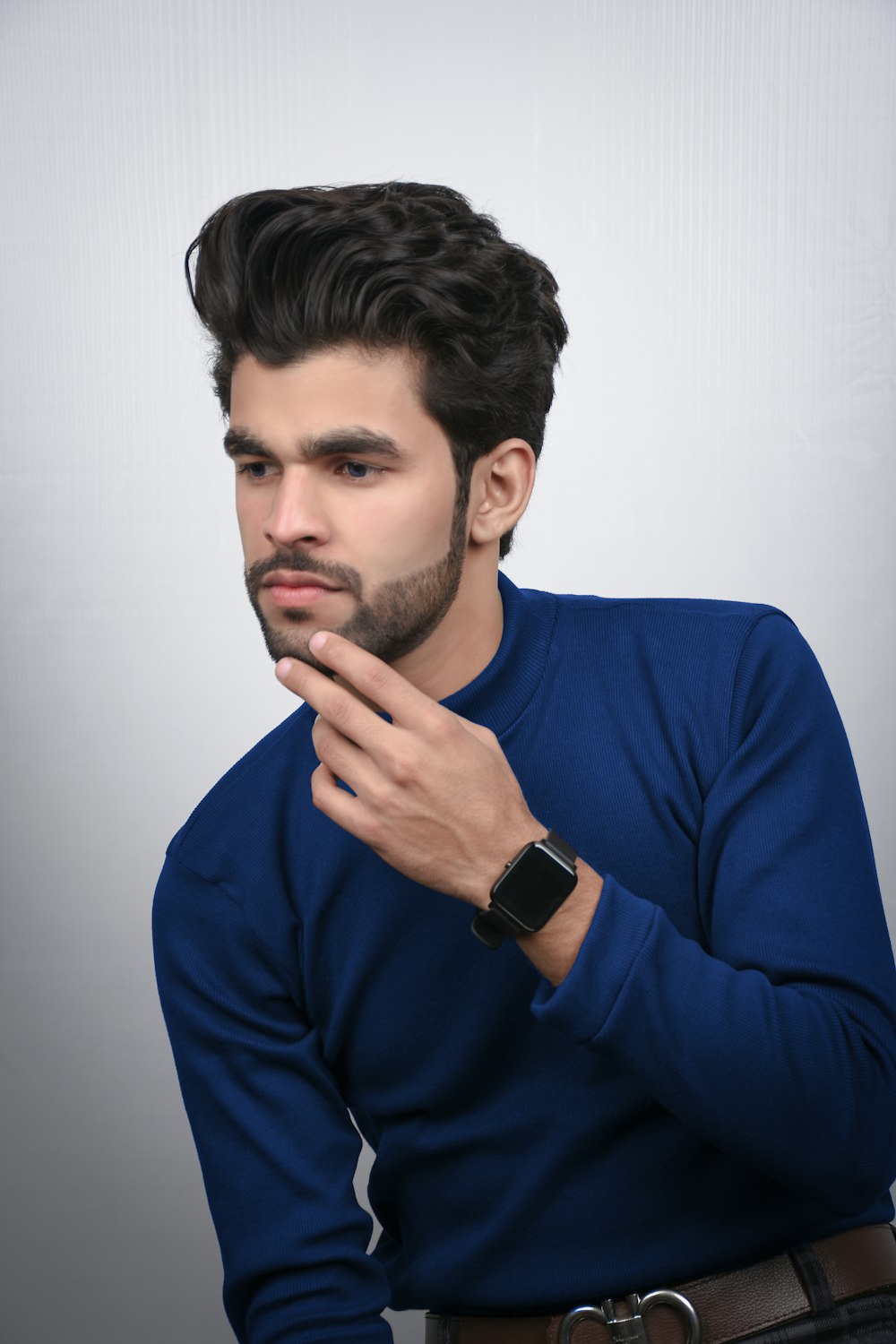 man in blue long sleeve shirt wearing black smart watch