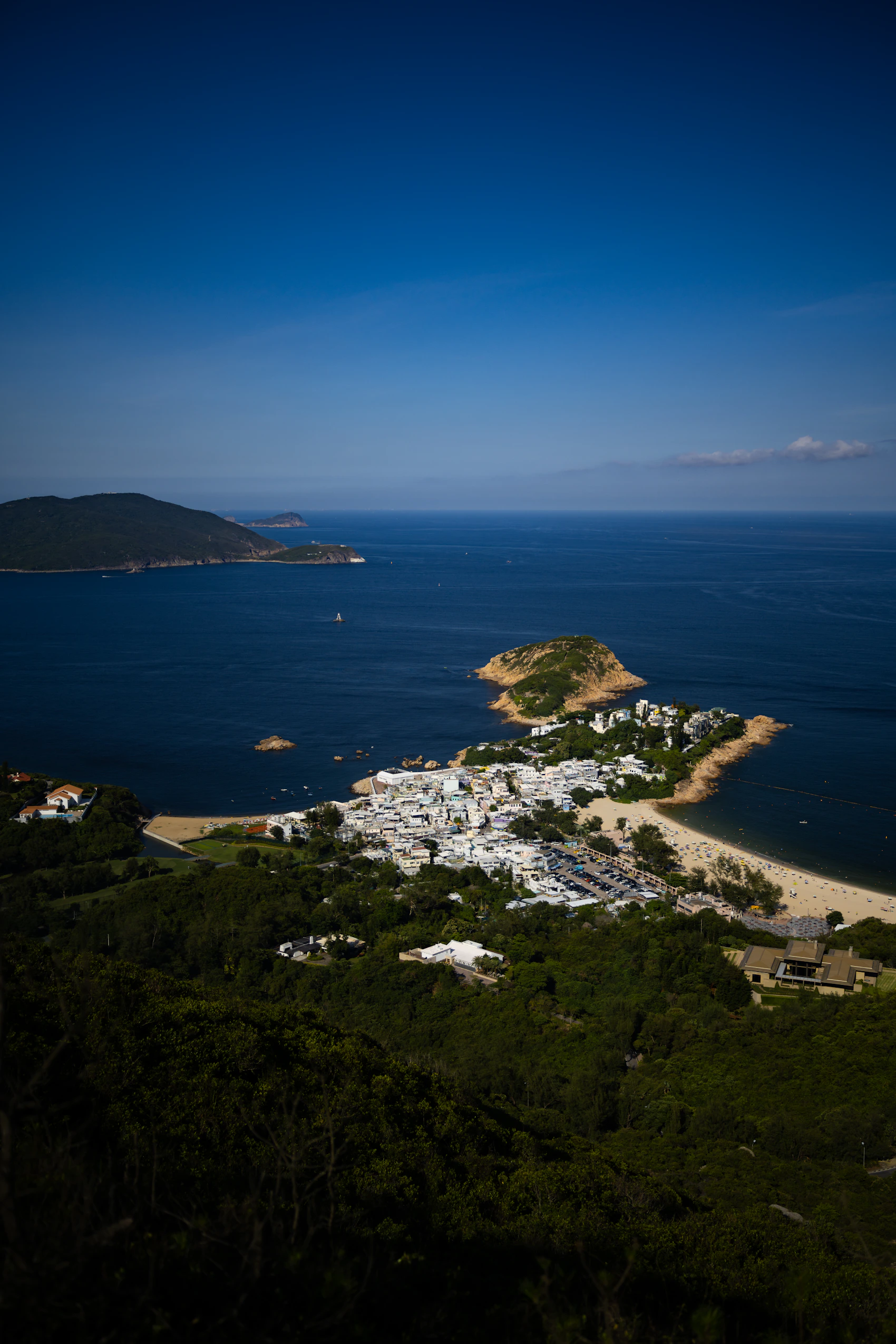 Green ridges and blue coastline seen from the Dragon's Back trail in Hong Kong