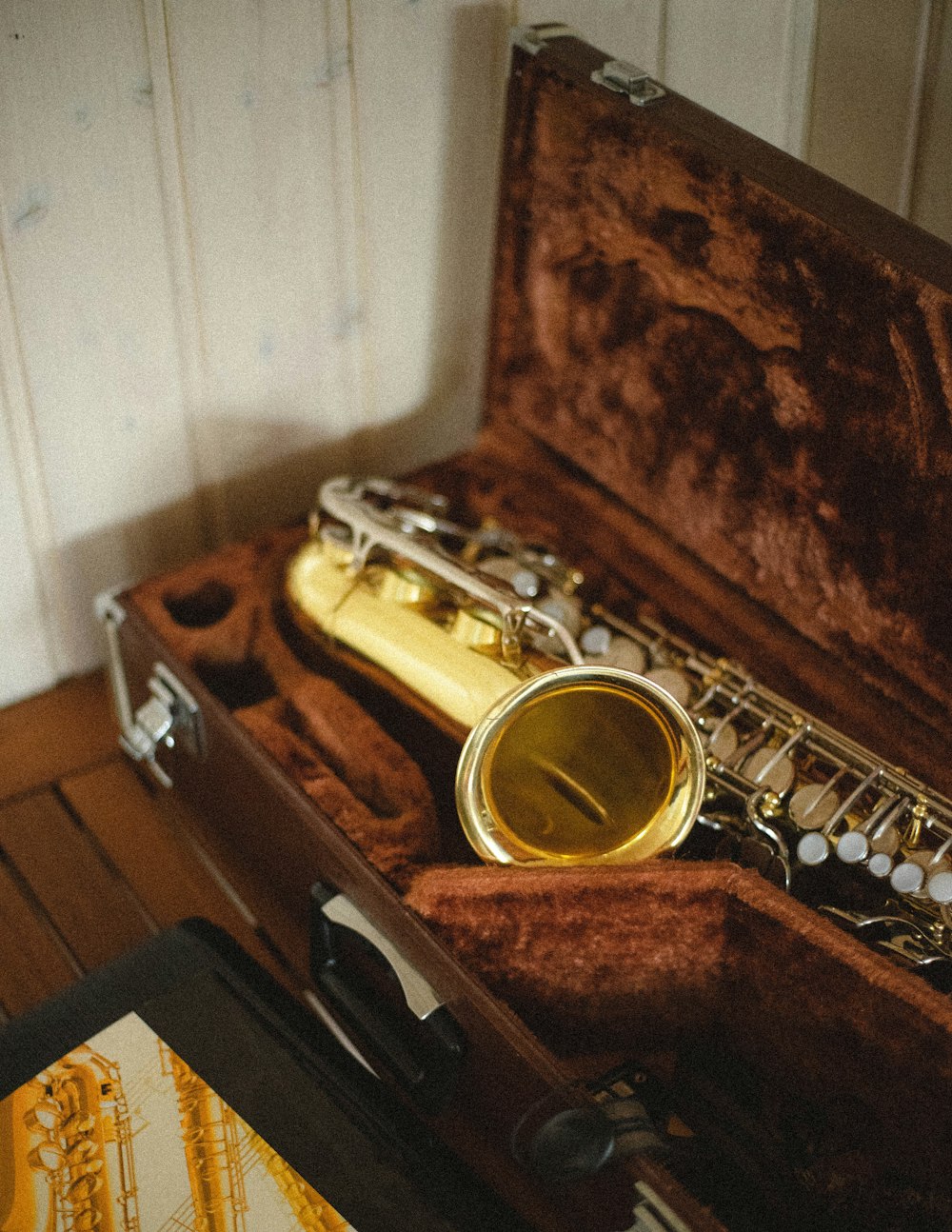 brass trumpet on brown wooden table