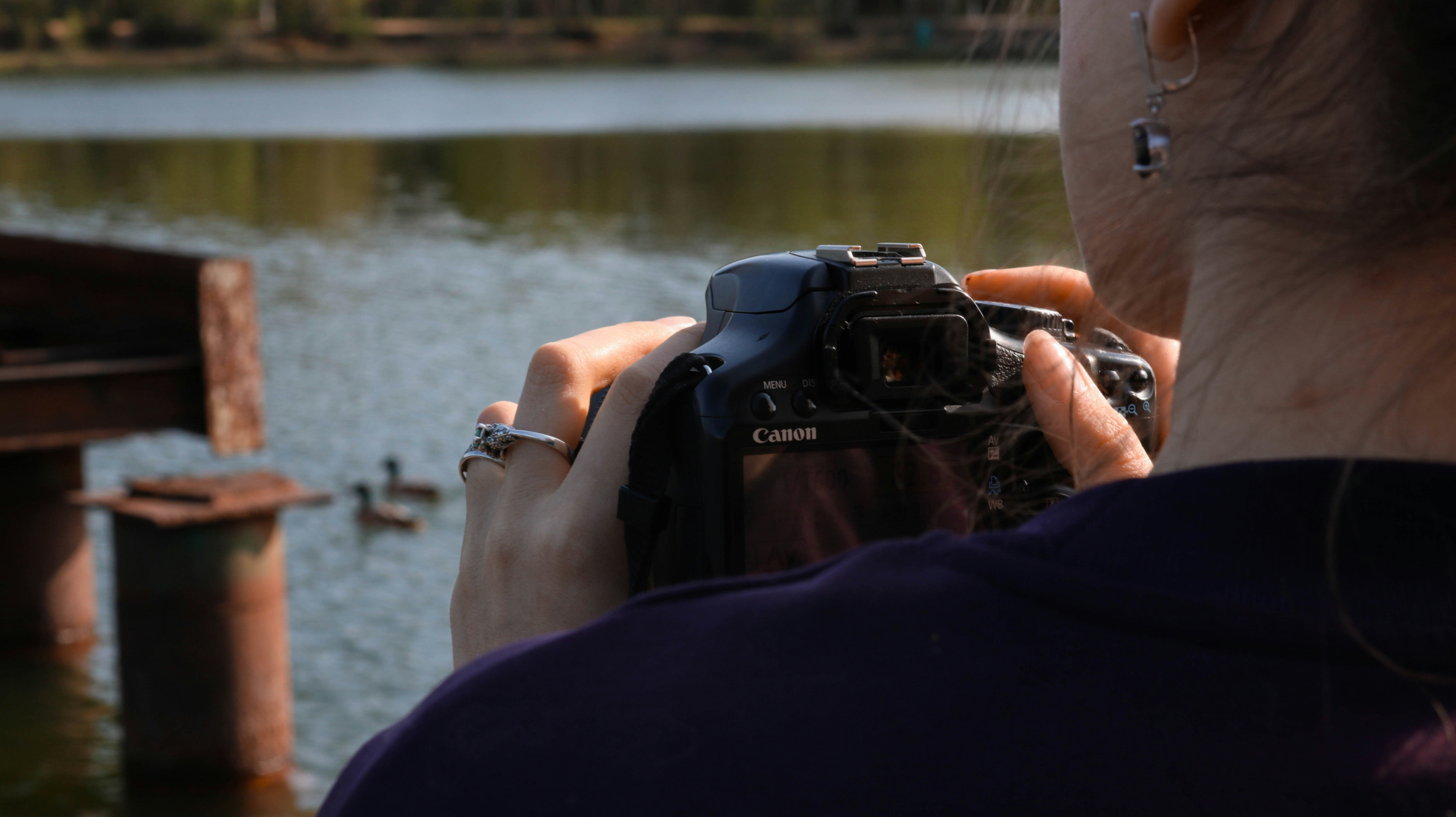 person holding black nikon dslr camera