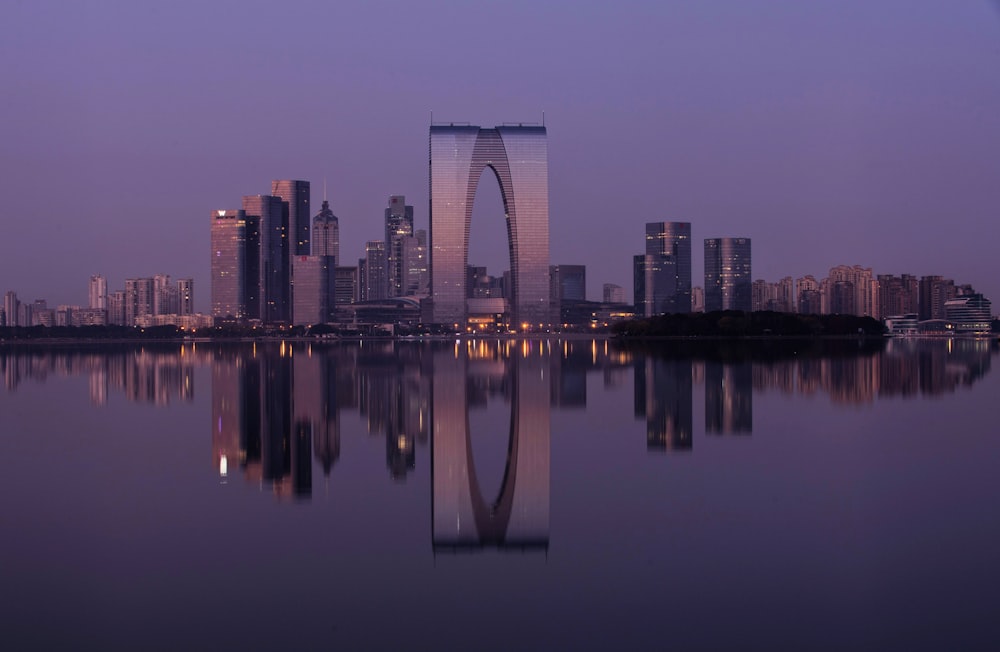 white concrete building near body of water during night time