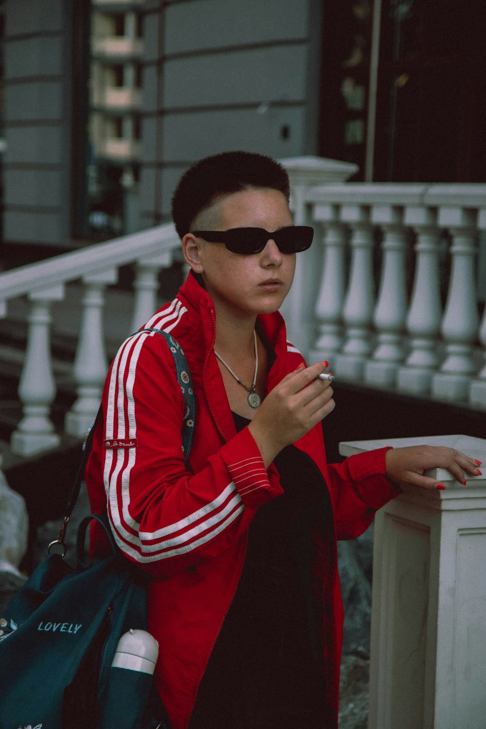 man in red and white striped long sleeve shirt wearing black sunglasses