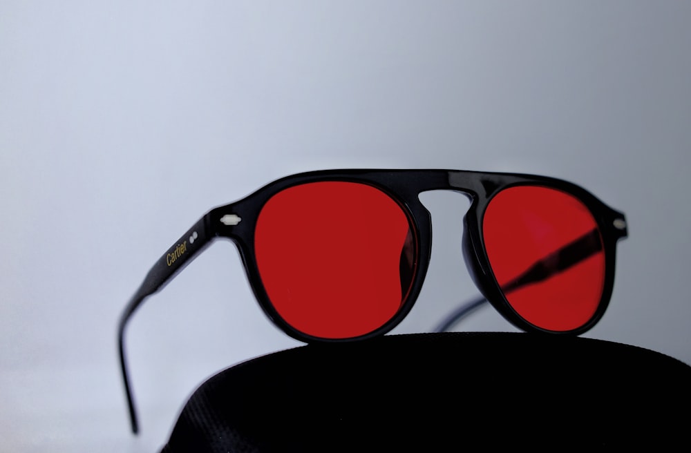 black framed sunglasses on white table