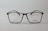 A pair of rectangular eyeglasses with a thin black frame, featuring the brand name 'Silhouette' on the right lens. The lenses are transparent, and small text is present on the left lens.