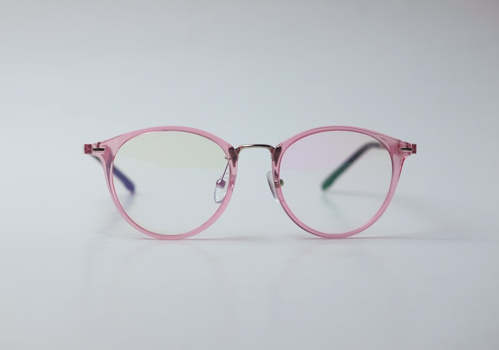 brown framed eyeglasses on white surface