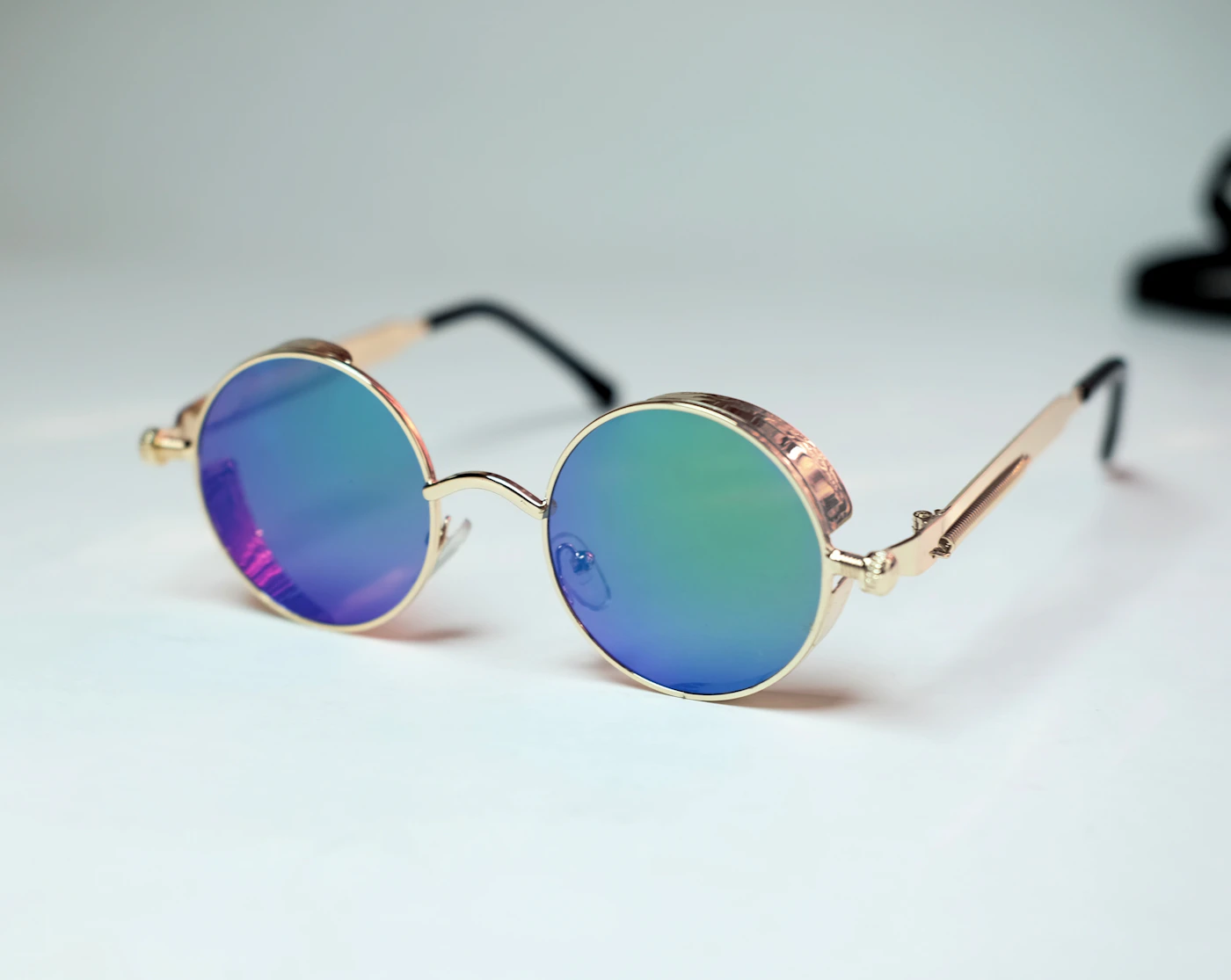 Champagne metal round sunglasses with aqua mirrored lenses on white