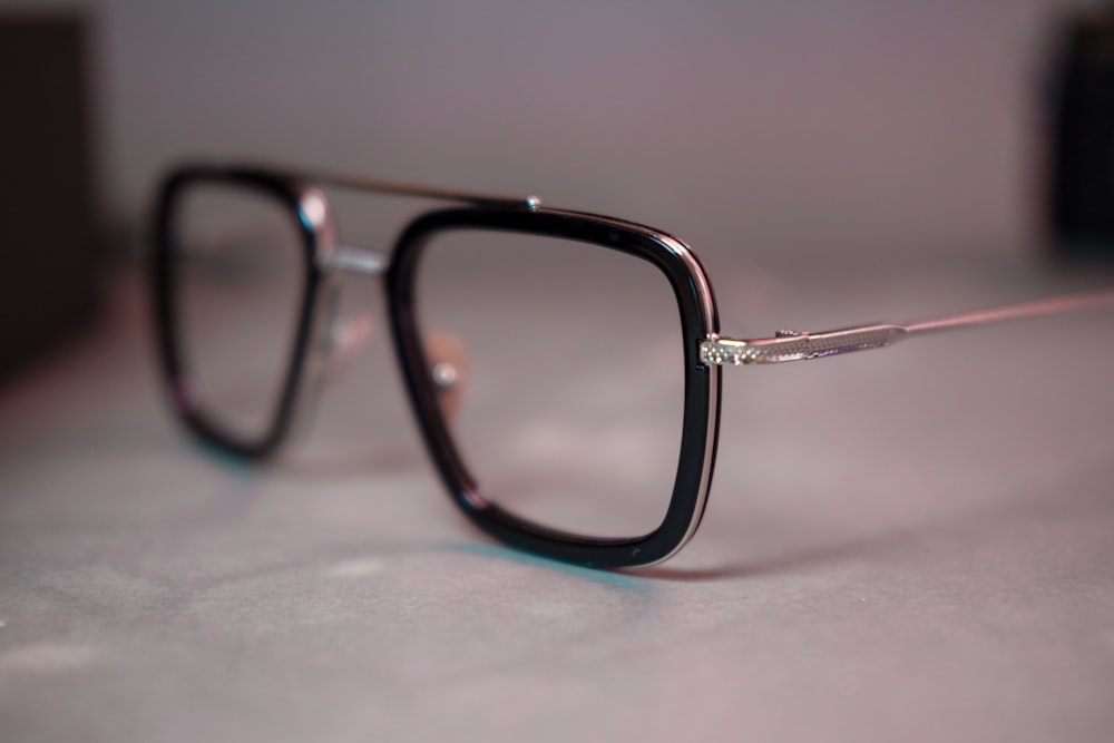 black framed eyeglasses on white table