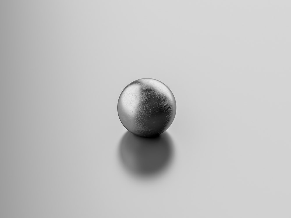 silver ball on white surface