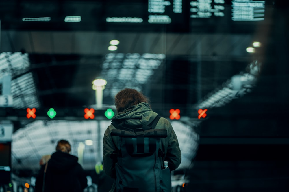 man in black jacket standing in front of people