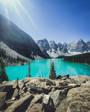 lake in the middle of mountains during daytime