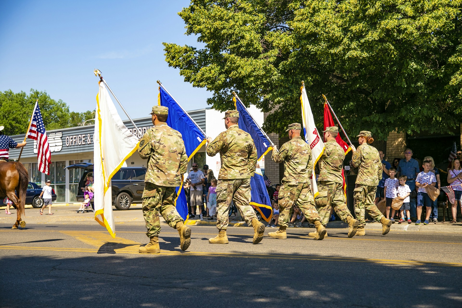 soldiers in brown and green camouflage uniform standing on road during daytime