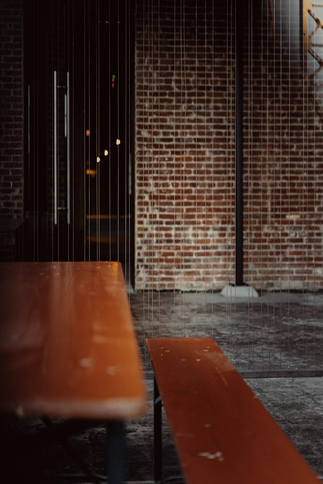 brown wooden table near brown brick wall