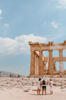 A group of tourists exploring the ancient ruins of Mohenjo-Daro under clear blue skies.