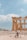 A group of travelers exploring ancient ruins under a clear blue sky.